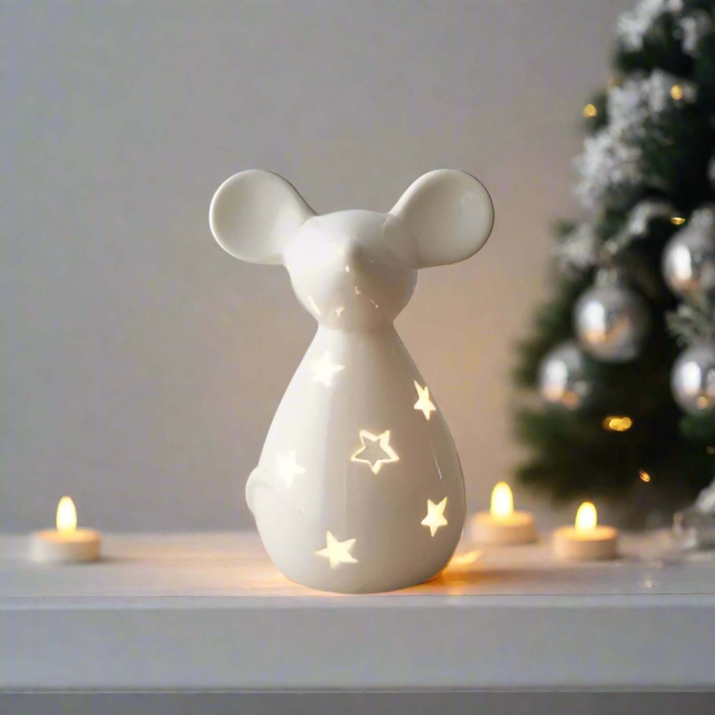 Cute and Simple Mouse Tealight Holder. Add a touch of whimsy to your holiday decor. This adorable mouse-shaped tealight holder, featuring a charming star cut-out decal and a sleek white finish, is the perfect way to bring a touch of festive cheer to your