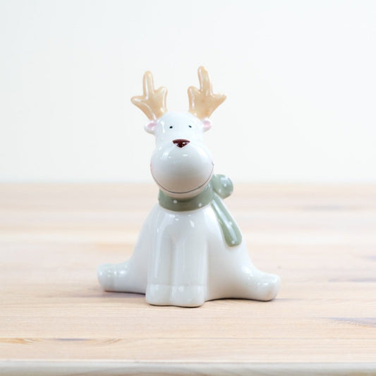 Ceramic reindeer figurine with a white body and brown nose 