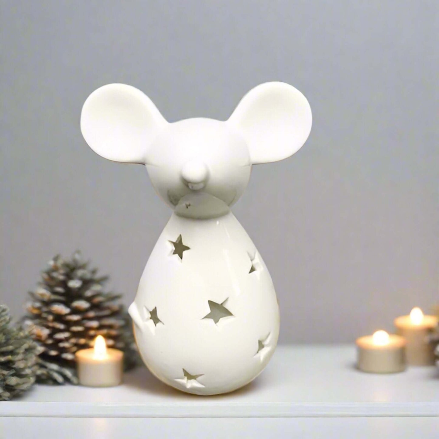 Cute and Simple Mouse Tealight Holder. Add a touch of whimsy to your holiday decor. This adorable mouse-shaped tealight holder, featuring a charming star cut-out decal and a sleek white finish, is the perfect way to bring a touch of festive cheer to your 