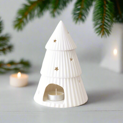 White ceramic Christmas tree wax melt burner with star decorations.